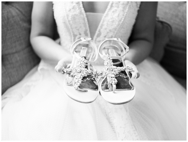 bride holding shoes while getting ready Ramble Creek bridal suite