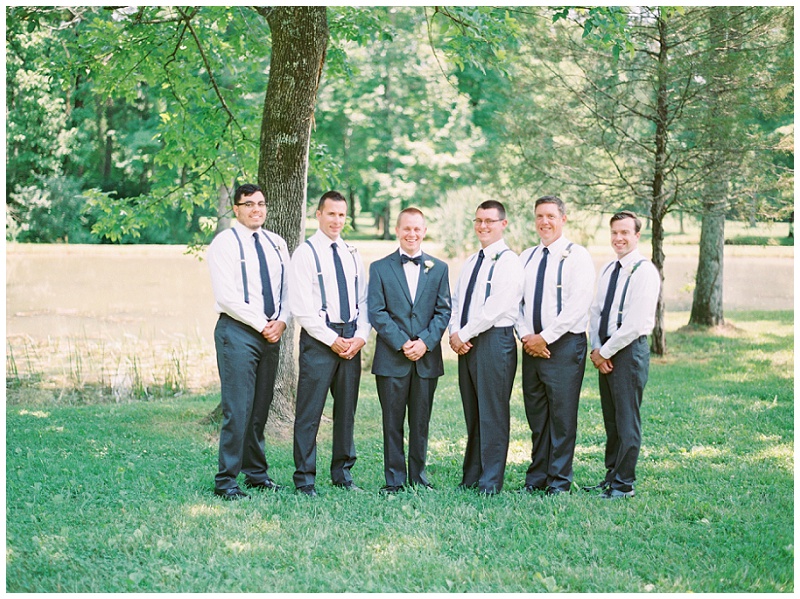 groom adjusting tie wedding day candid