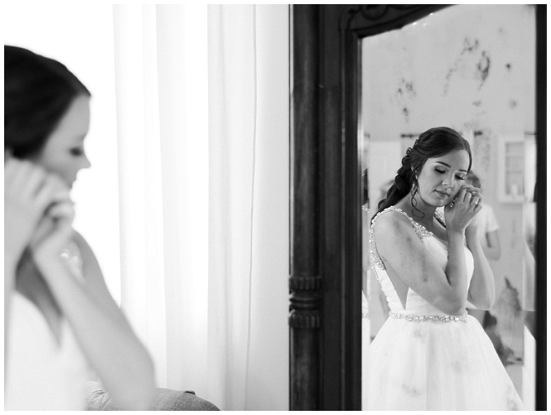 bride putting on earrings 