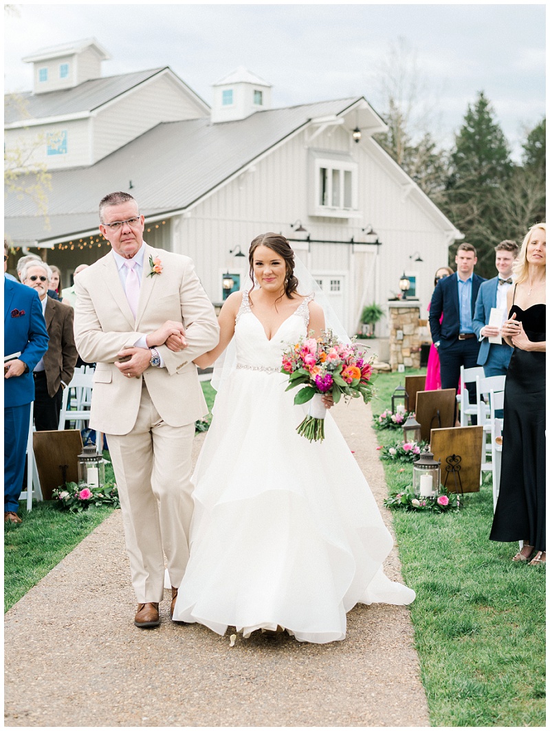 bride walking down aisle barn venue