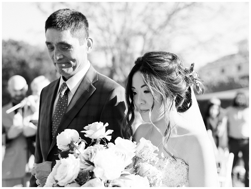 bride and dad walking down aisle barn venue