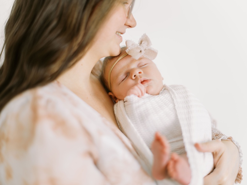 newborn baby with older sibling posed safely studio