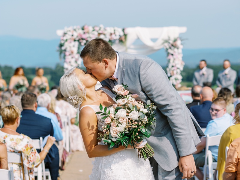 Rustic ceremony arch at barn wedding venue