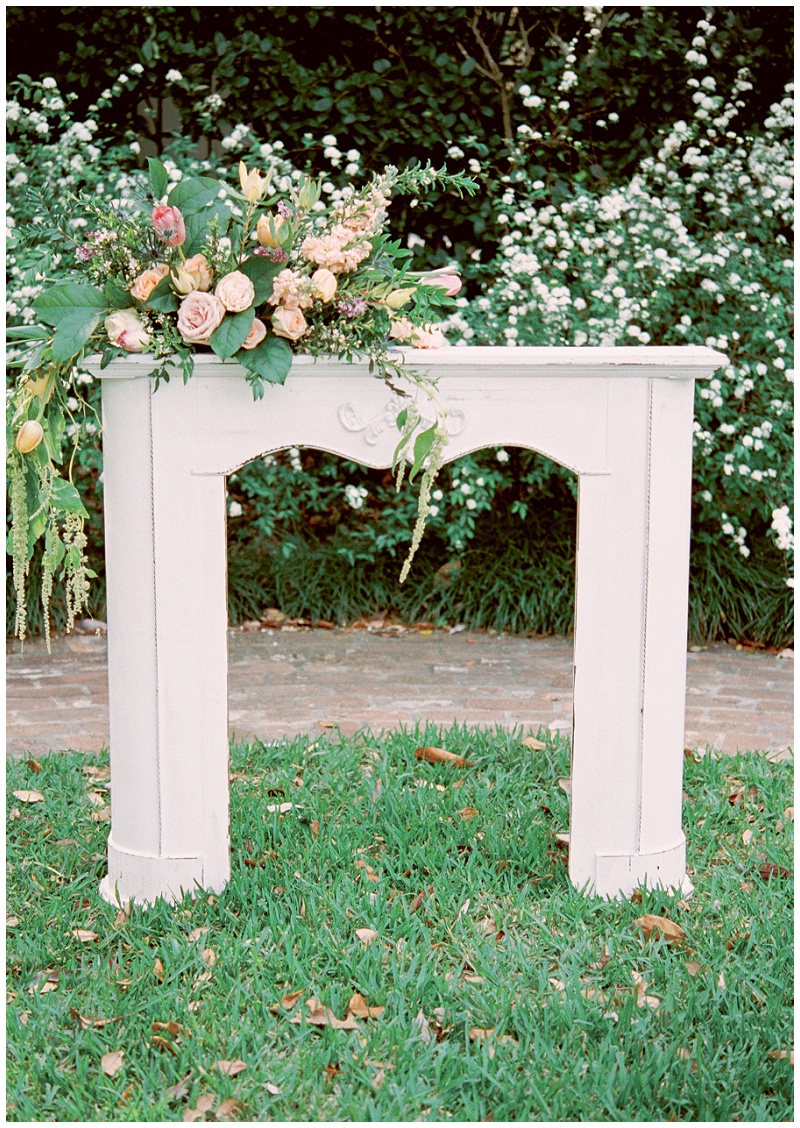 garden ceremony fireplace with floral decor Houston wedding venue