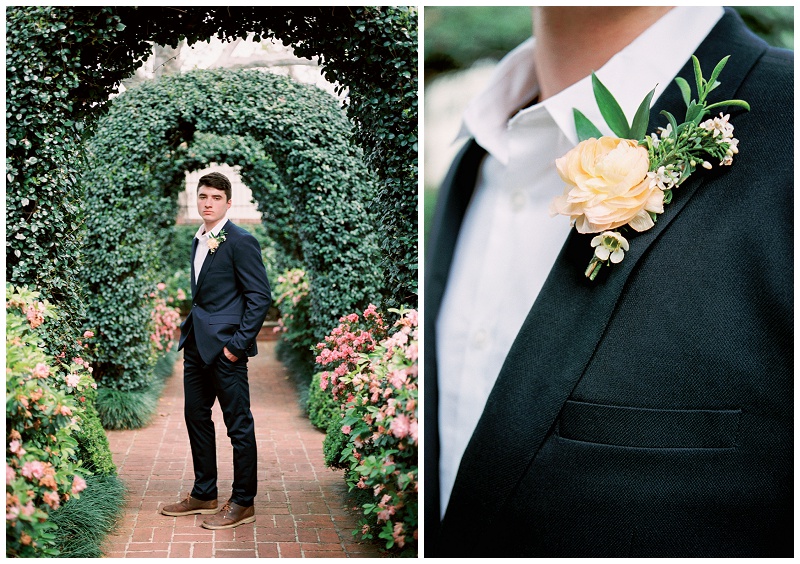 groom standing among roses at River Oaks Garden Club