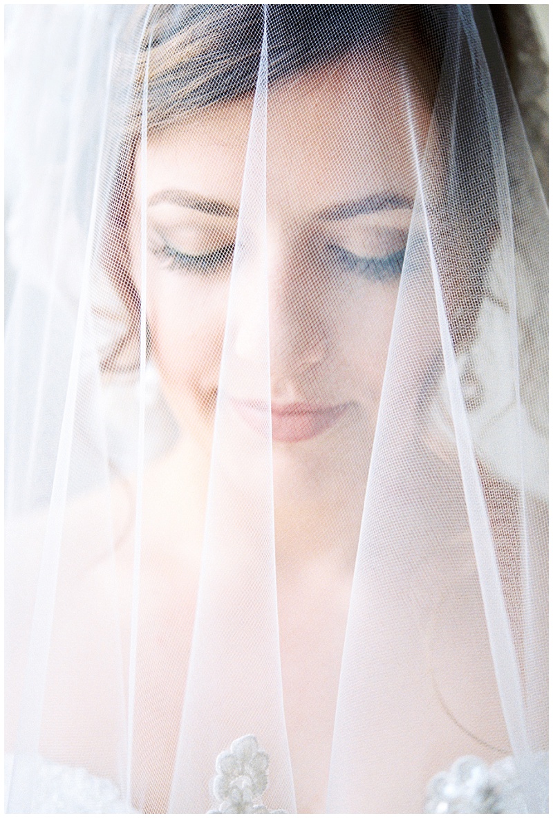 Bride getting ready in natural light at Tri-Cities Tennessee wedding venue with soft window lighting for bridal portraits