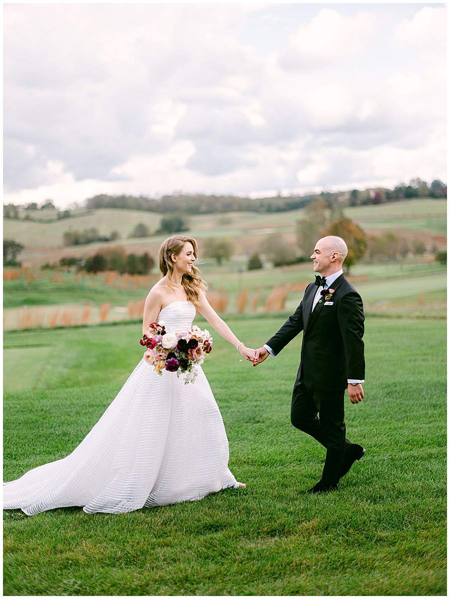 Bride and groom walking together at The Olde Farm wedding