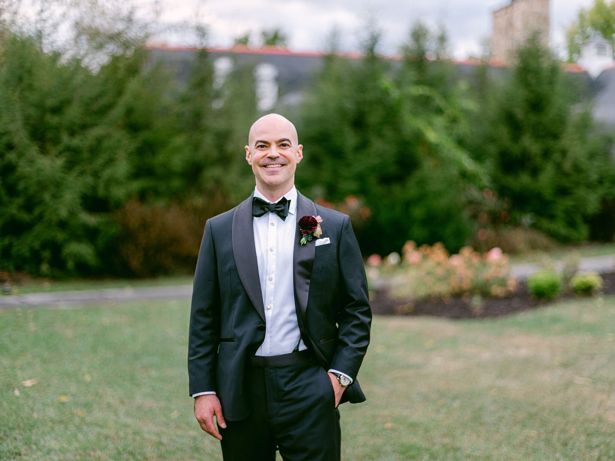 Groom standing outdoors at The Olde Farm wedding venue