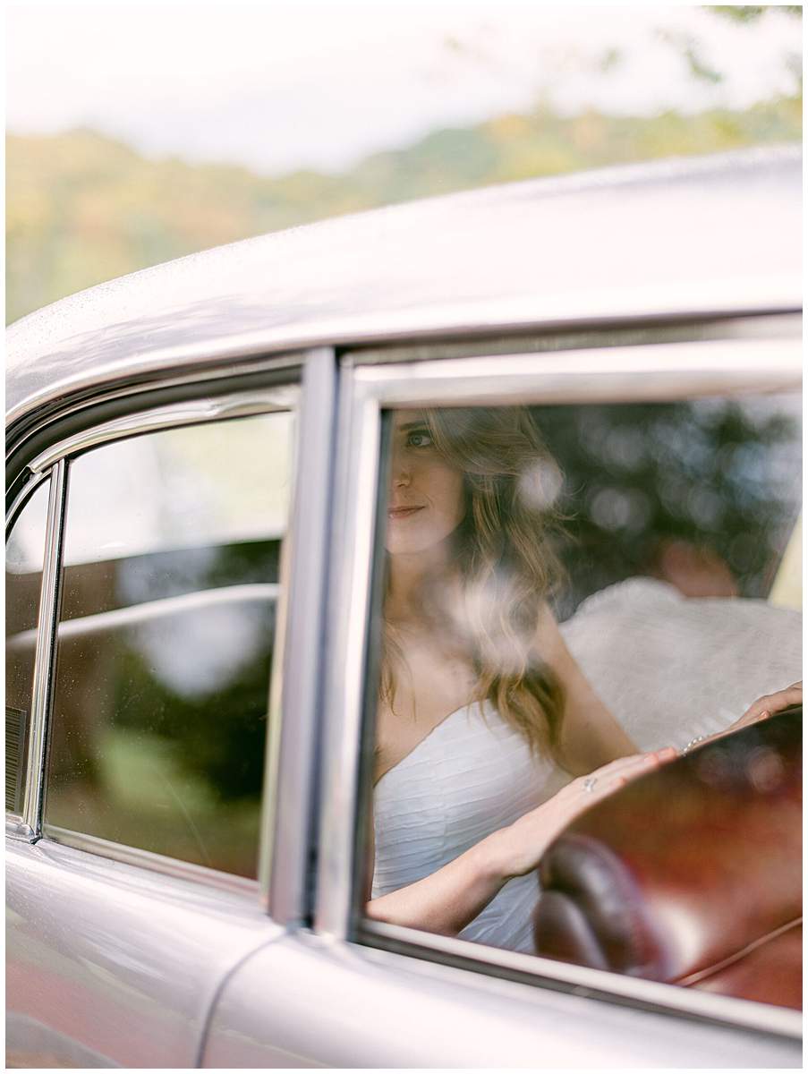 Bride in an antique car at The Olde Farm wedding