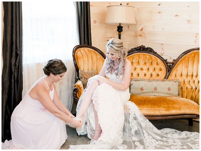 Bride putting on dress at The Homeplace at Johnston Farm wedding