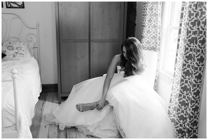 Bride putting on wedding dress at The Millstone wedding venue