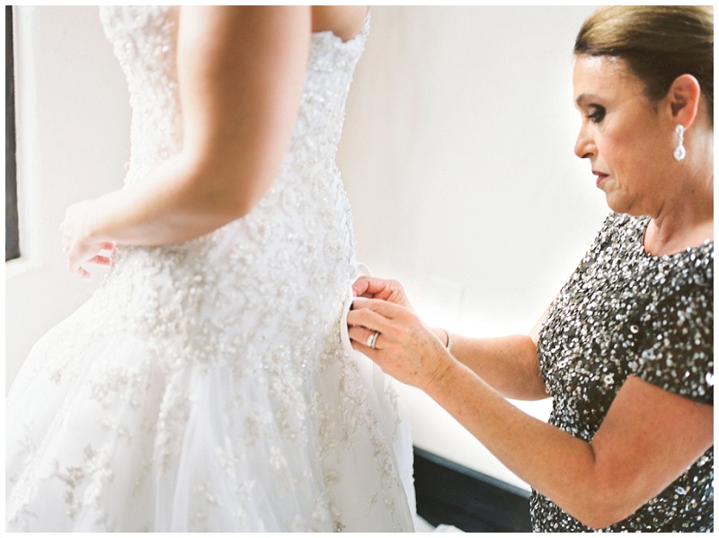 Bride putting on dress at Chateau Selah