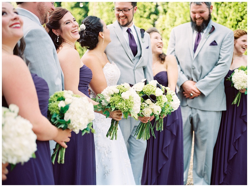 Bridal party posing outdoors in summer light