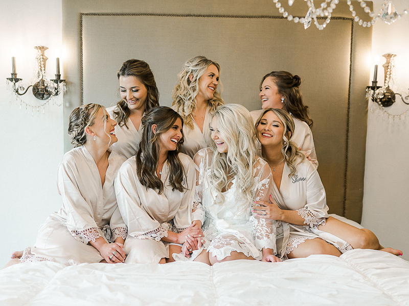 Bridesmaids helping bride get ready at wedding venue