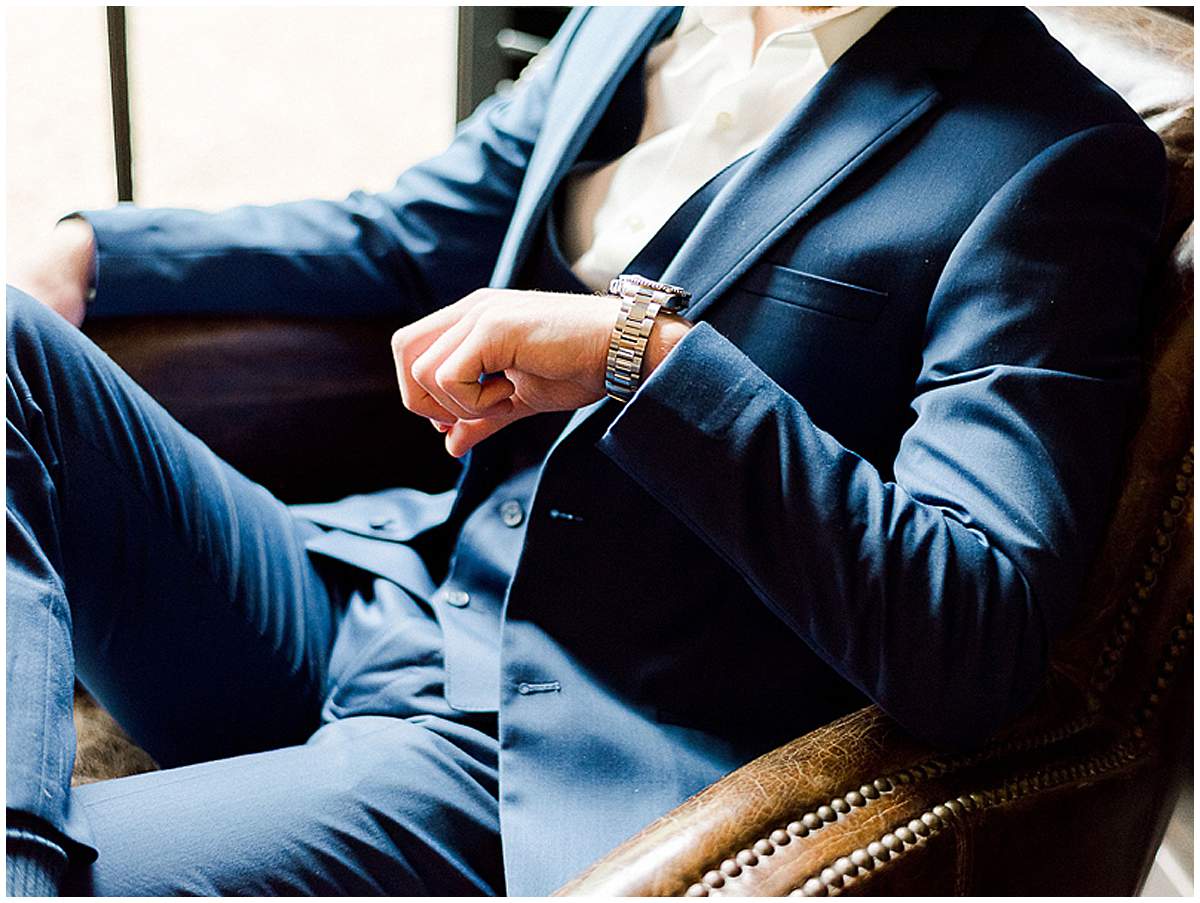 Groom adjusting suit before wedding ceremony