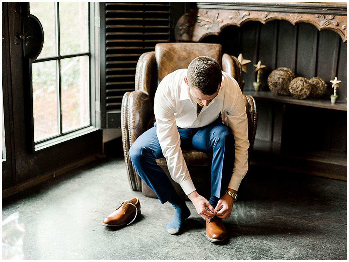 Groom adjusting suit before wedding ceremony