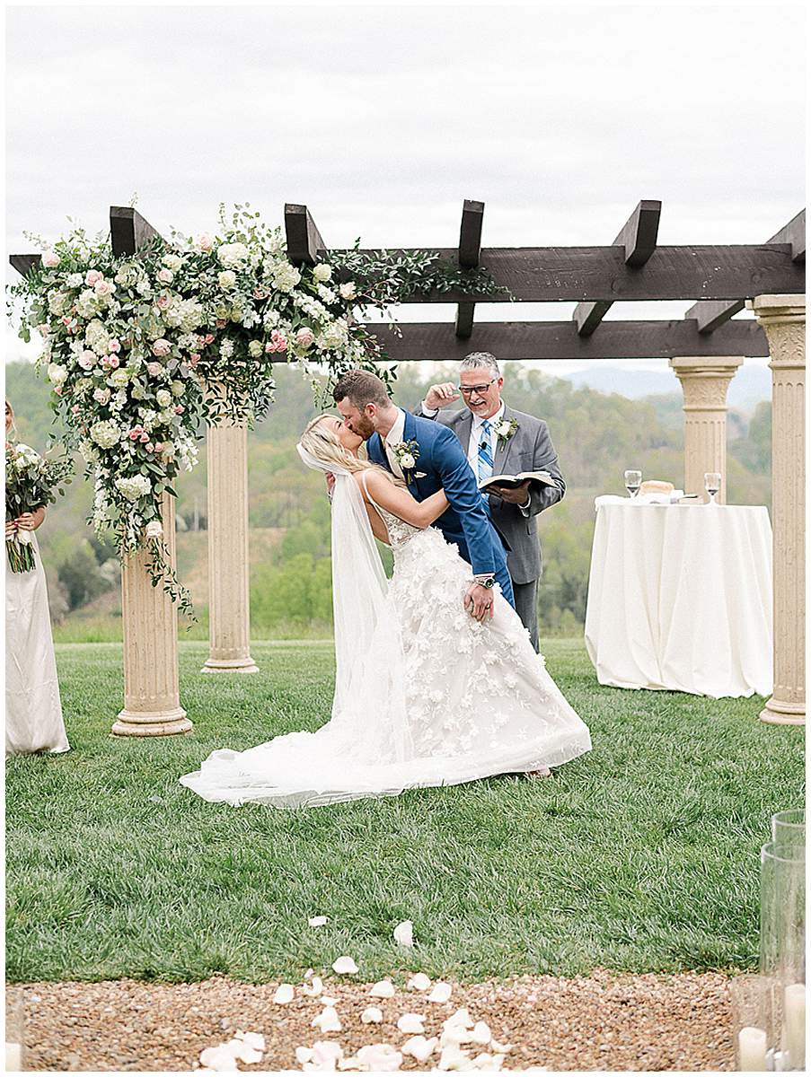 Bride and groom dip kiss ceremony moment