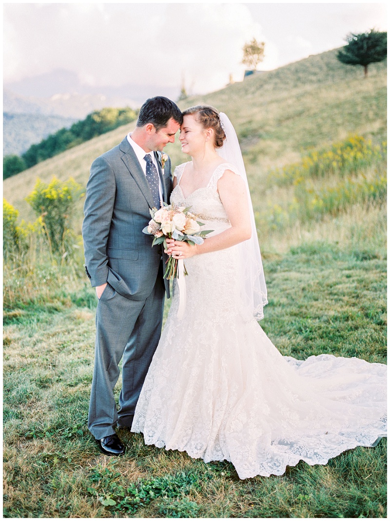 newlyweds standing close mountain overlook wedding