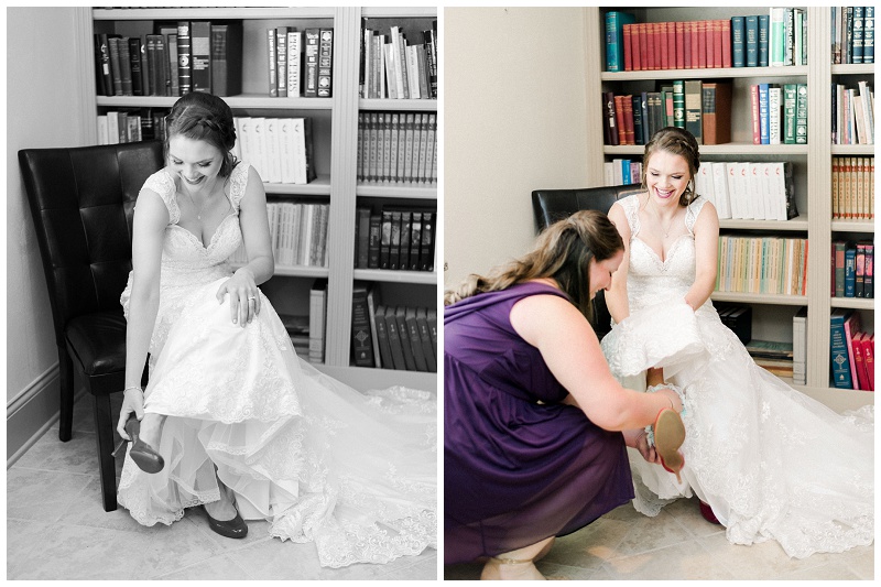 bride putting on shoes with bridesmaids help on the wedding morning