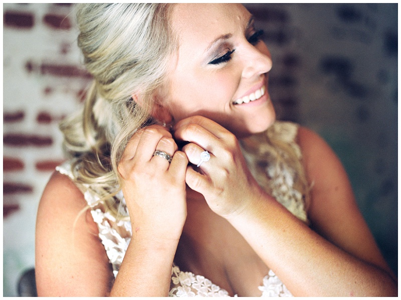 bride putting on earrings Old Woolen Mill