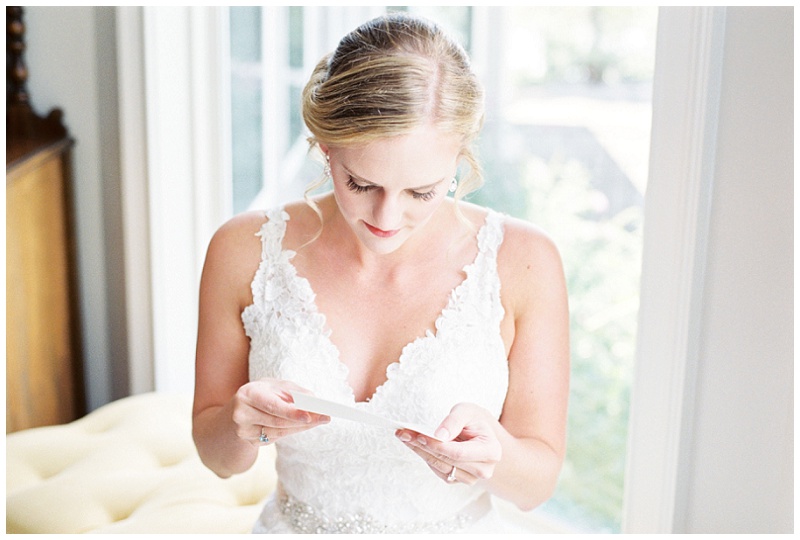 bride reading grooms letter at home wedding