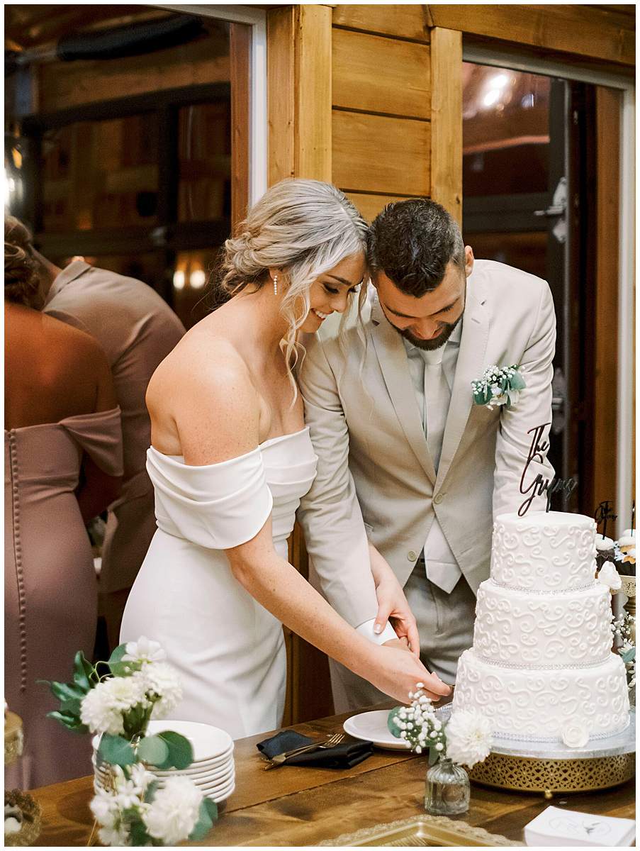 newlyweds cutting cake at their fall wedding TN newlyweds cutting cake at their fall wedding TN