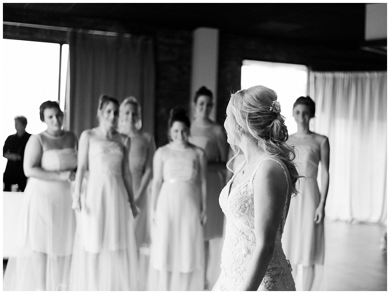 bridesmaids first look with bride wearing dress