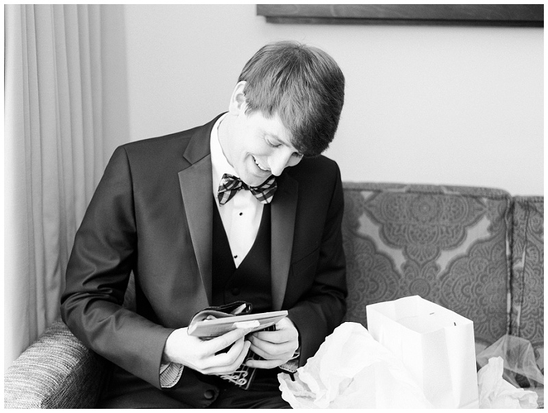 groom tying tie wedding morning