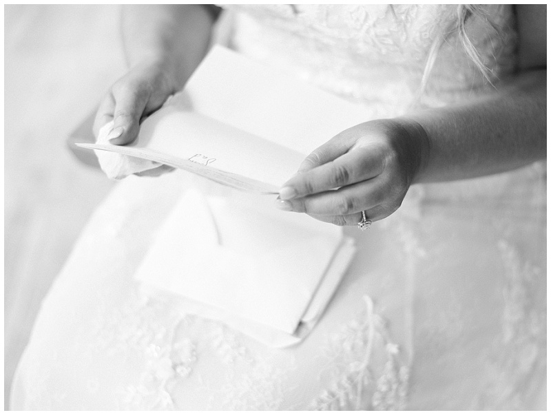 bride reading grooms letter at Side Porch venue