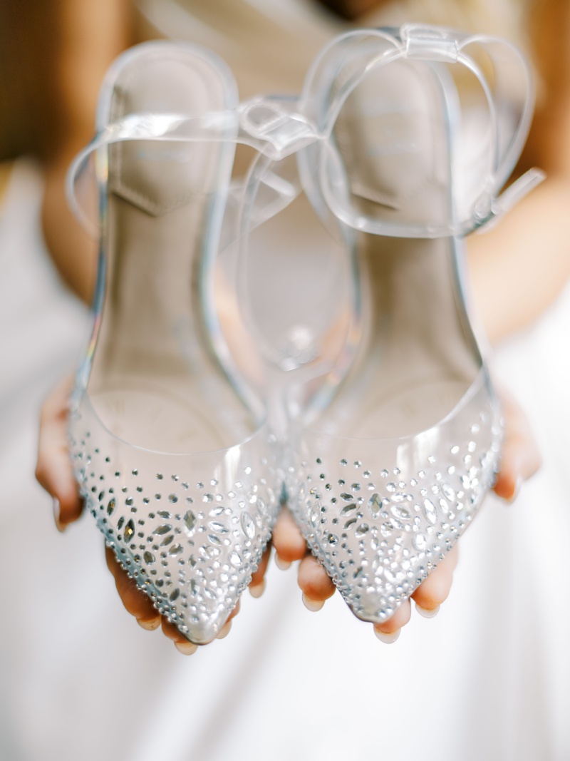 relaxed bride holding wedding shoes morning Nashville TN