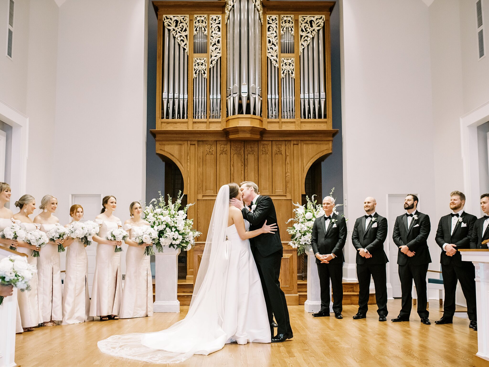 bride and groom first kiss at Paris Yates Chapel wedding ceremony