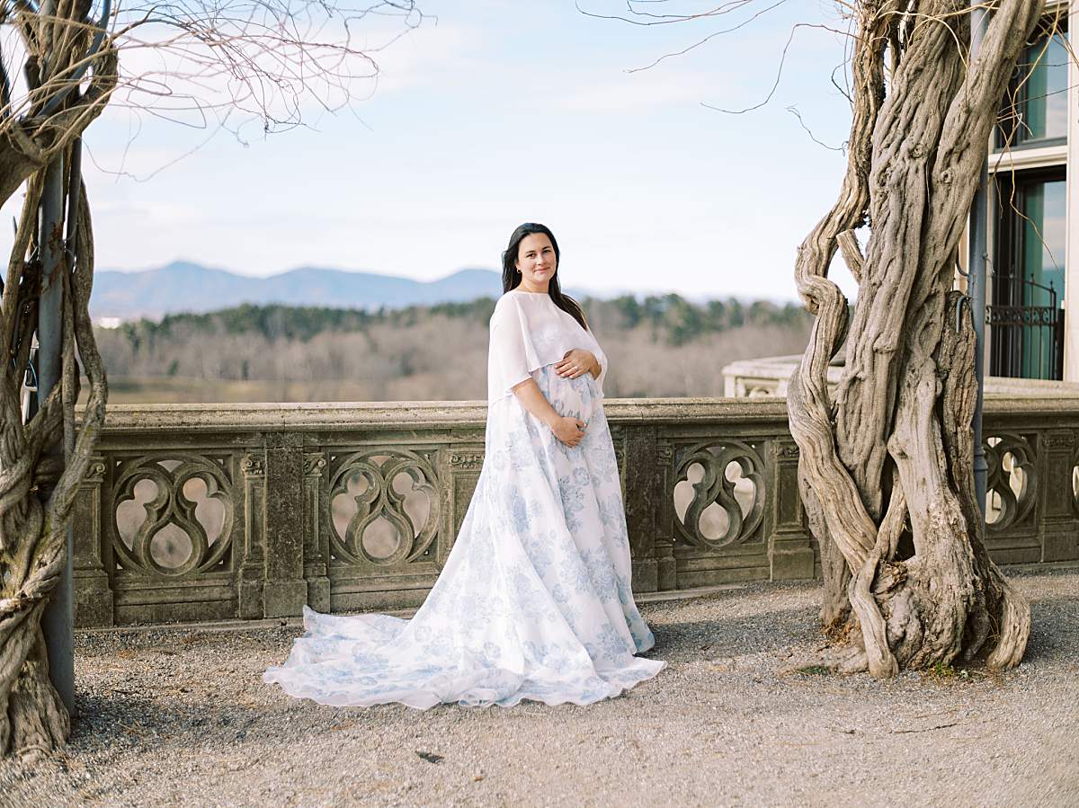 Elegant maternity dress flowing in the wind at the Biltmore Estate.