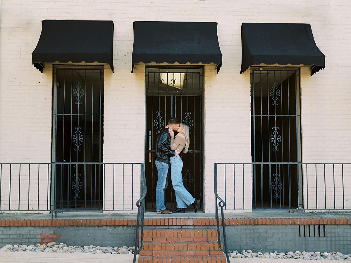 Elegant engagement portrait of a couple in a stylish urban Greenville setting. Elegant engagement portrait of a couple in a stylish urban Greenville setting.