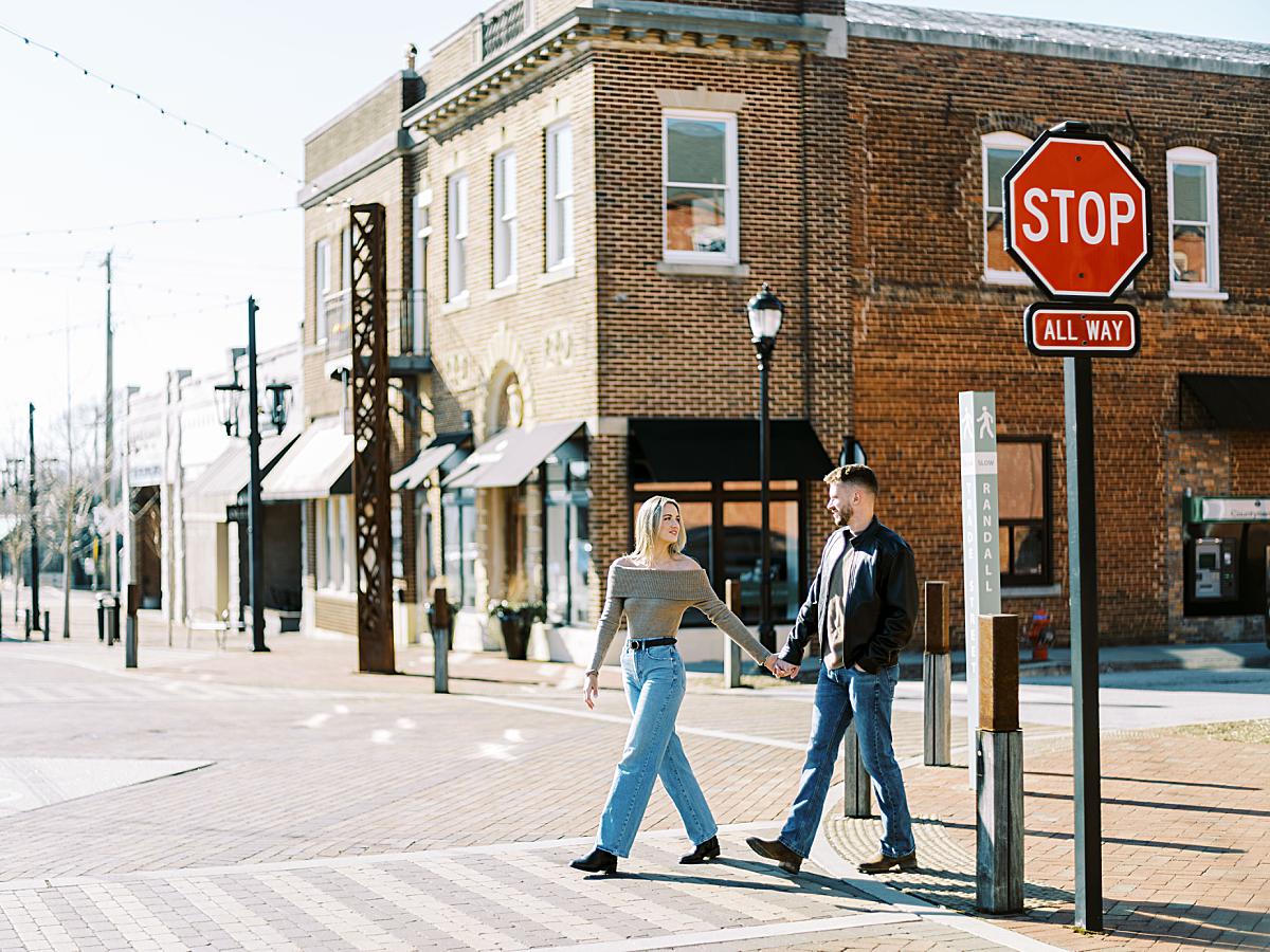 Natural light portrait of a couple walking across the street enjoying their engagement session in South Carolina. Natural light portrait of a couple walking across the street enjoying their engagement session in South Carolina.