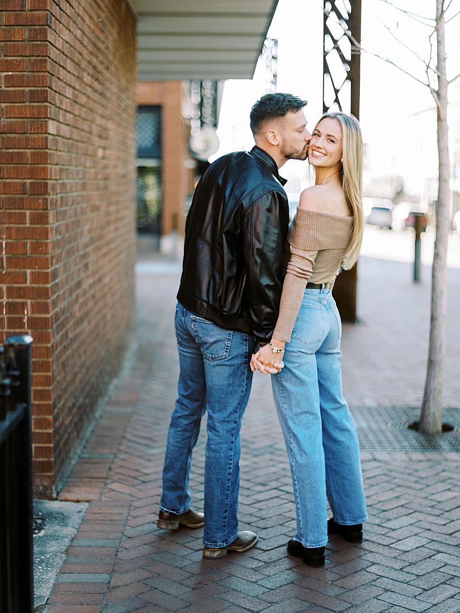 Couple walking hand-in-hand through historic downtown Greenville streets. Couple walking hand-in-hand through historic downtown Greenville streets.