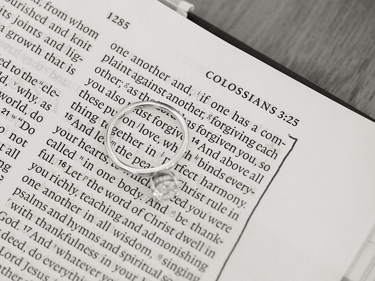 Close-up of the engagement ring laying on grooms bible. Close-up of the engagement ring laying on grooms bible.