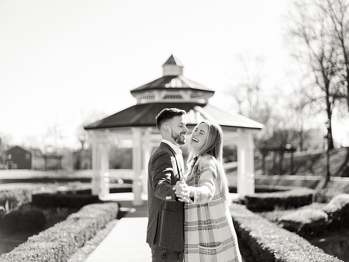 Bride laughing with groom while they looking at each other during their shoot. Bride laughing with groom while they looking at each other during their shoot.