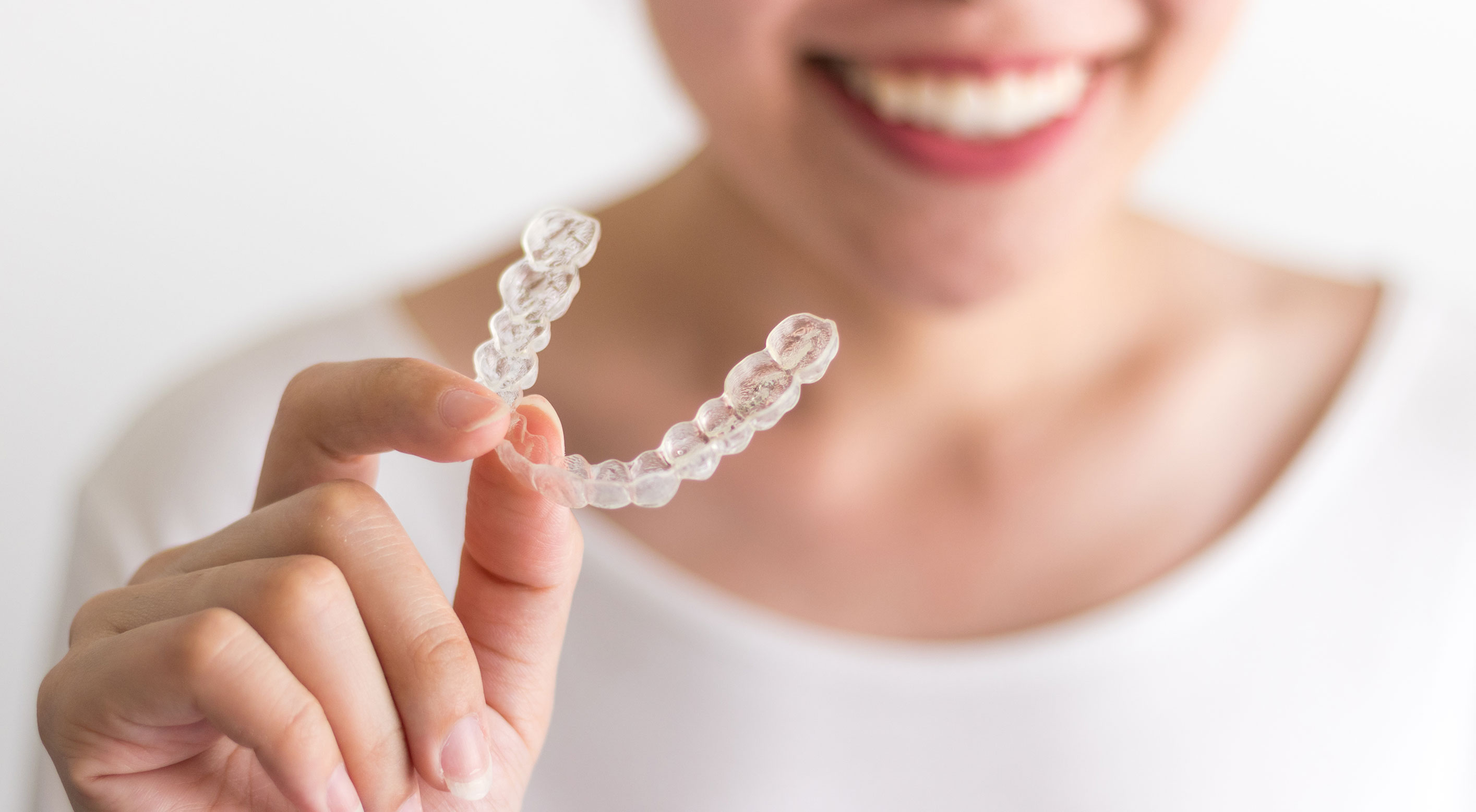 Woman holding invisalign