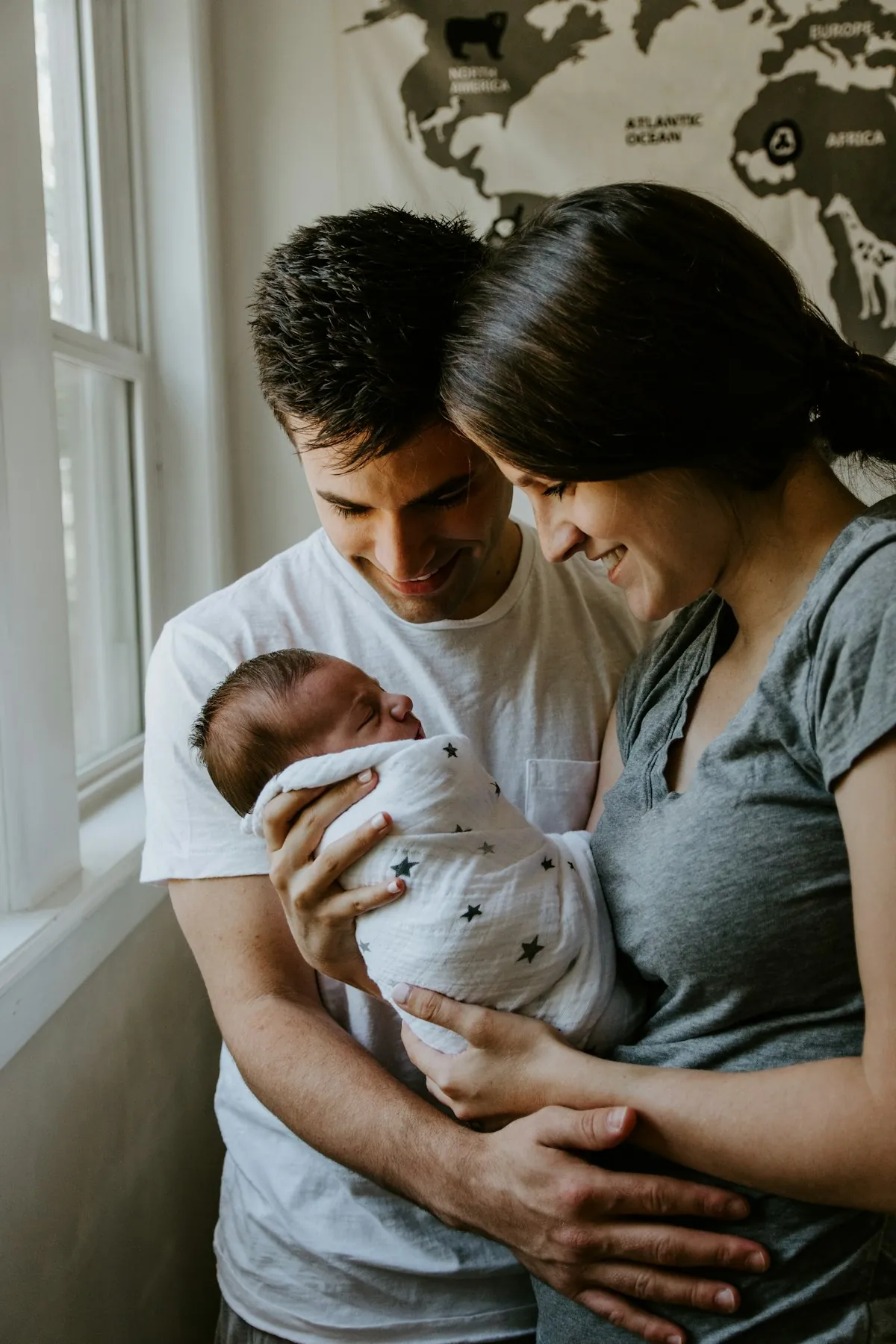 Parents holding their baby at home