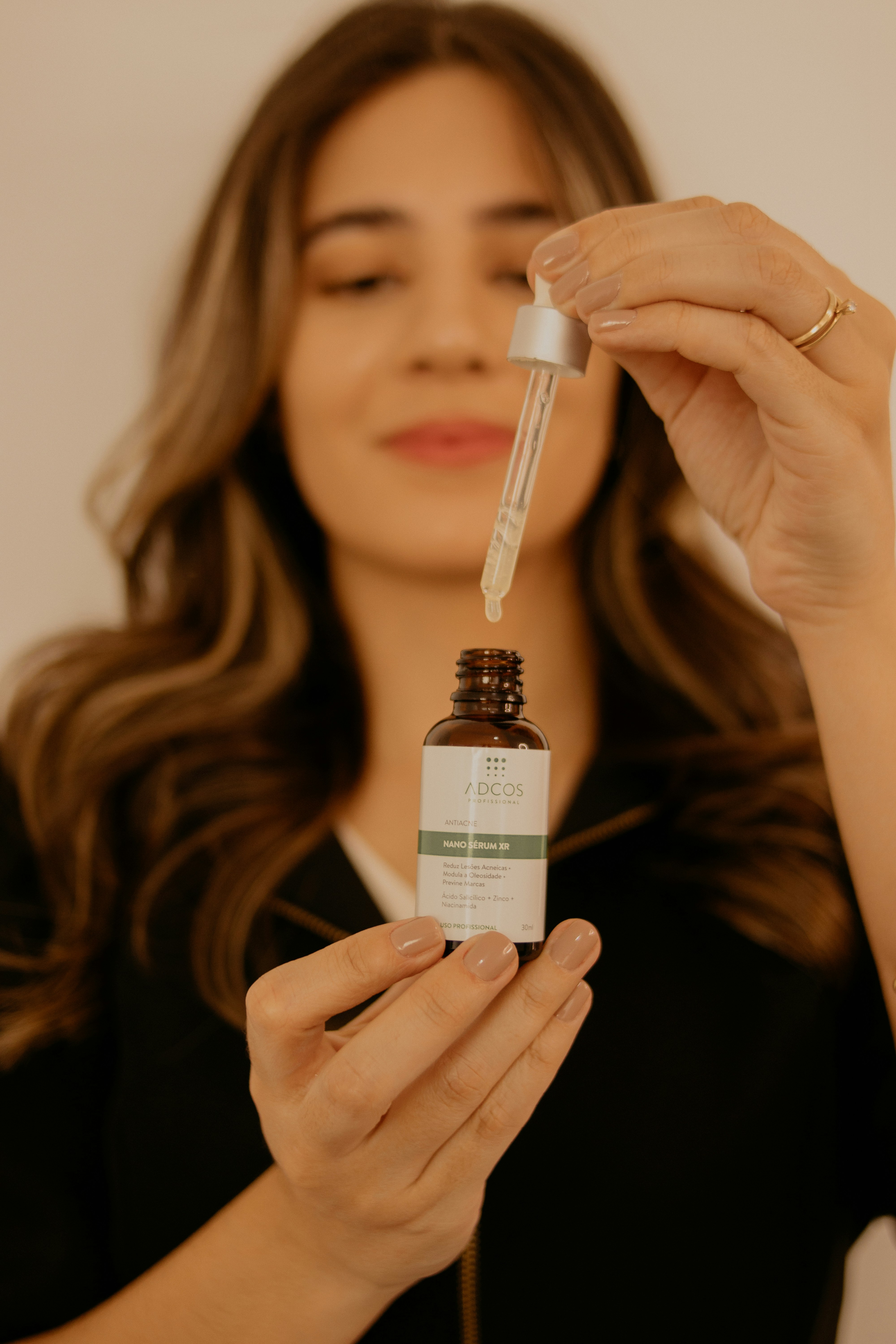 Close-up of skincare serum being applied to explain niacinamide and peptide ingredients