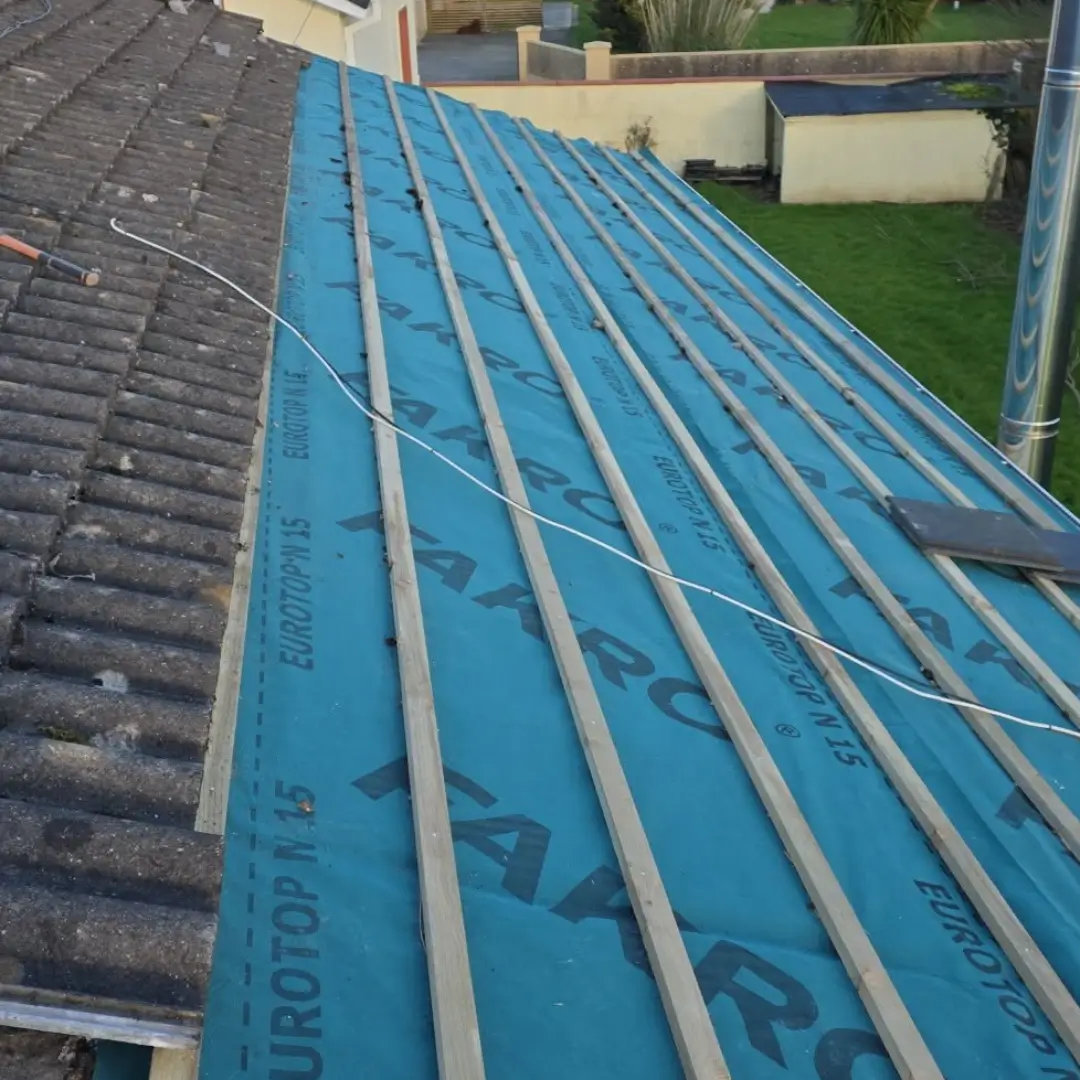 Tile roof stripped to battens with breather membrane
