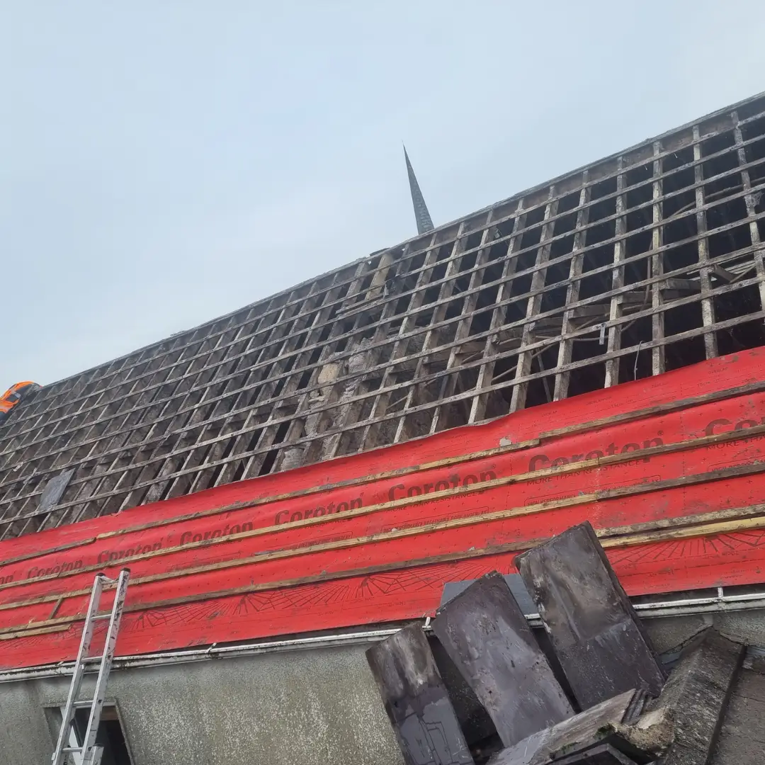 Slate roof stripped to battens before relay