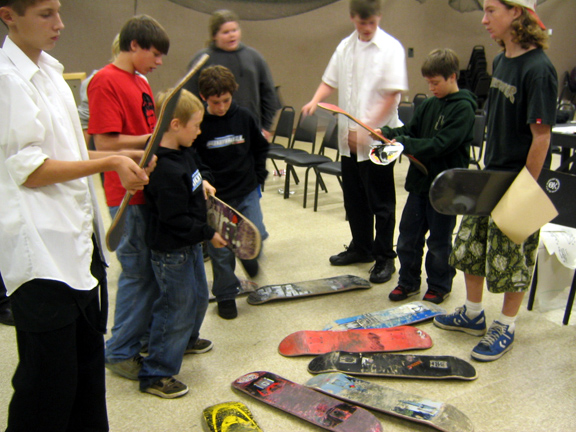 Young skateboarders discussing skateboards during a participatory design workshop