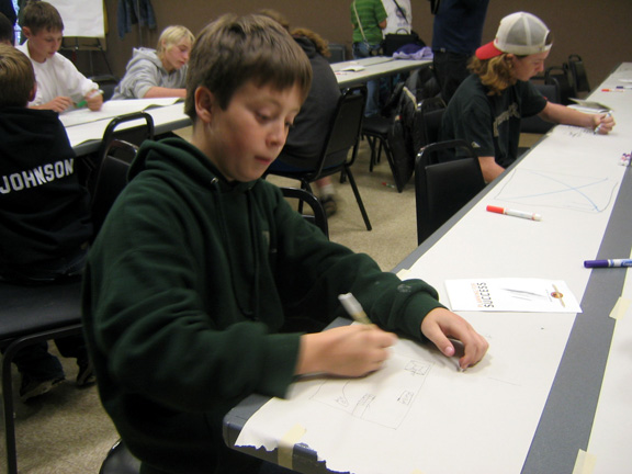 Young skateboarder drawing during a community design workshop