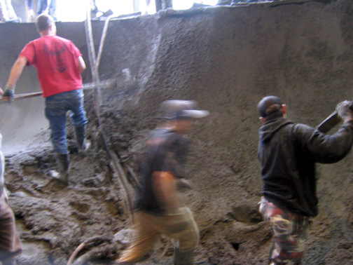 Workers placing concrete during skatepark construction