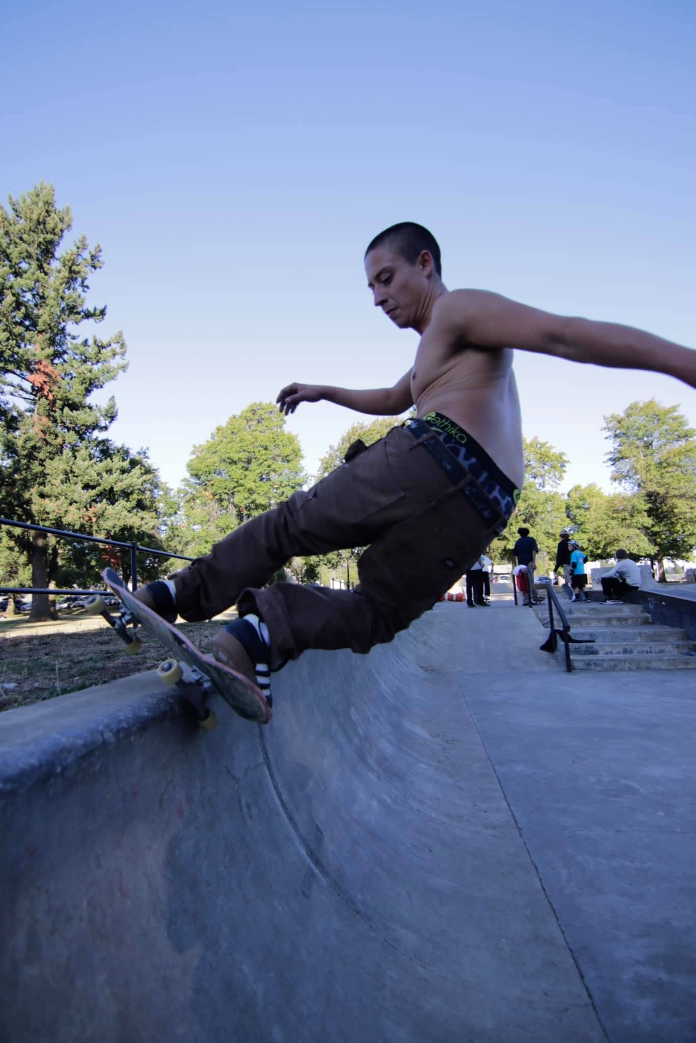 Adult skateboarder skating frontside at Glenhaven Skatepark in Portland