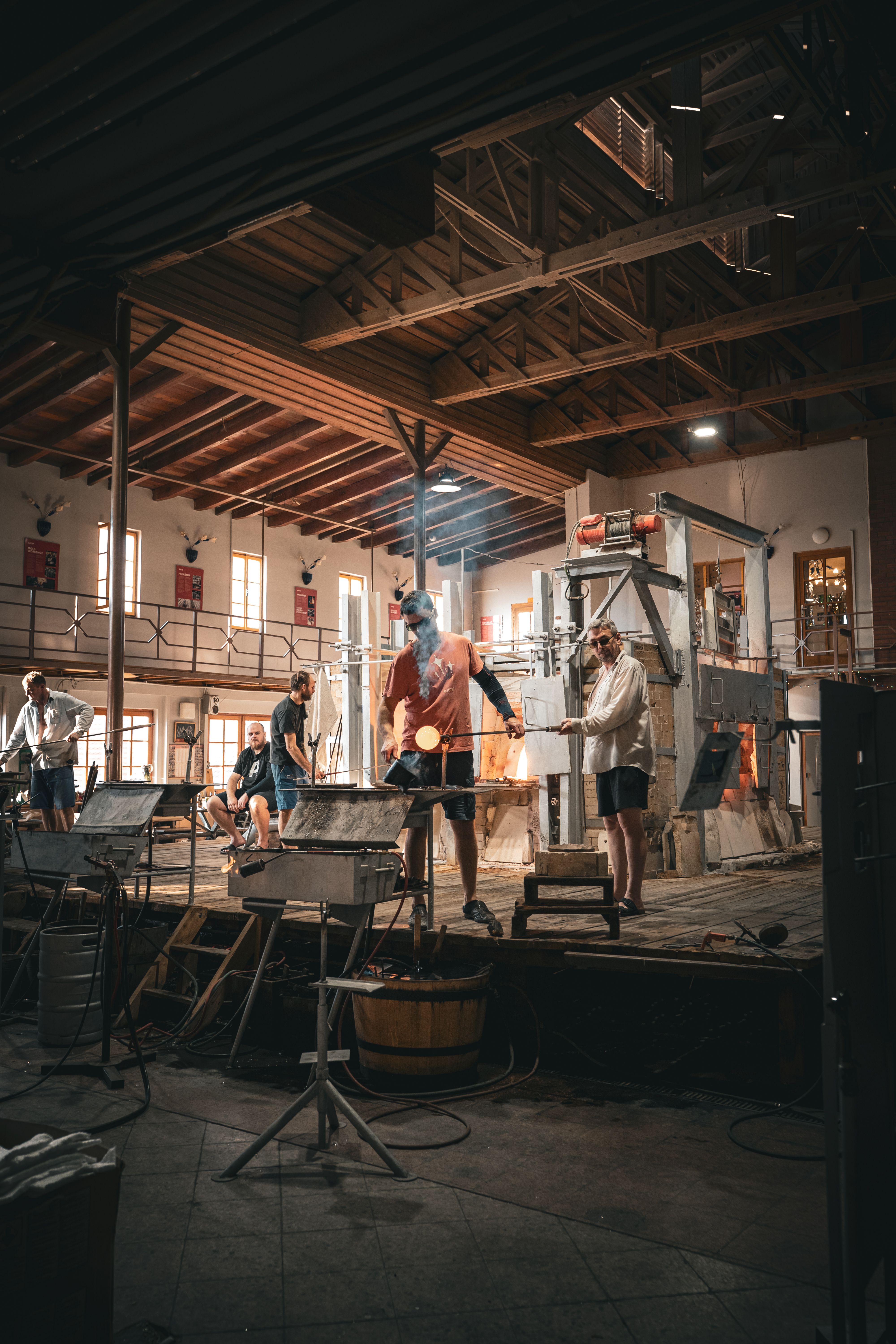 People working together in a glassmaking workshop
