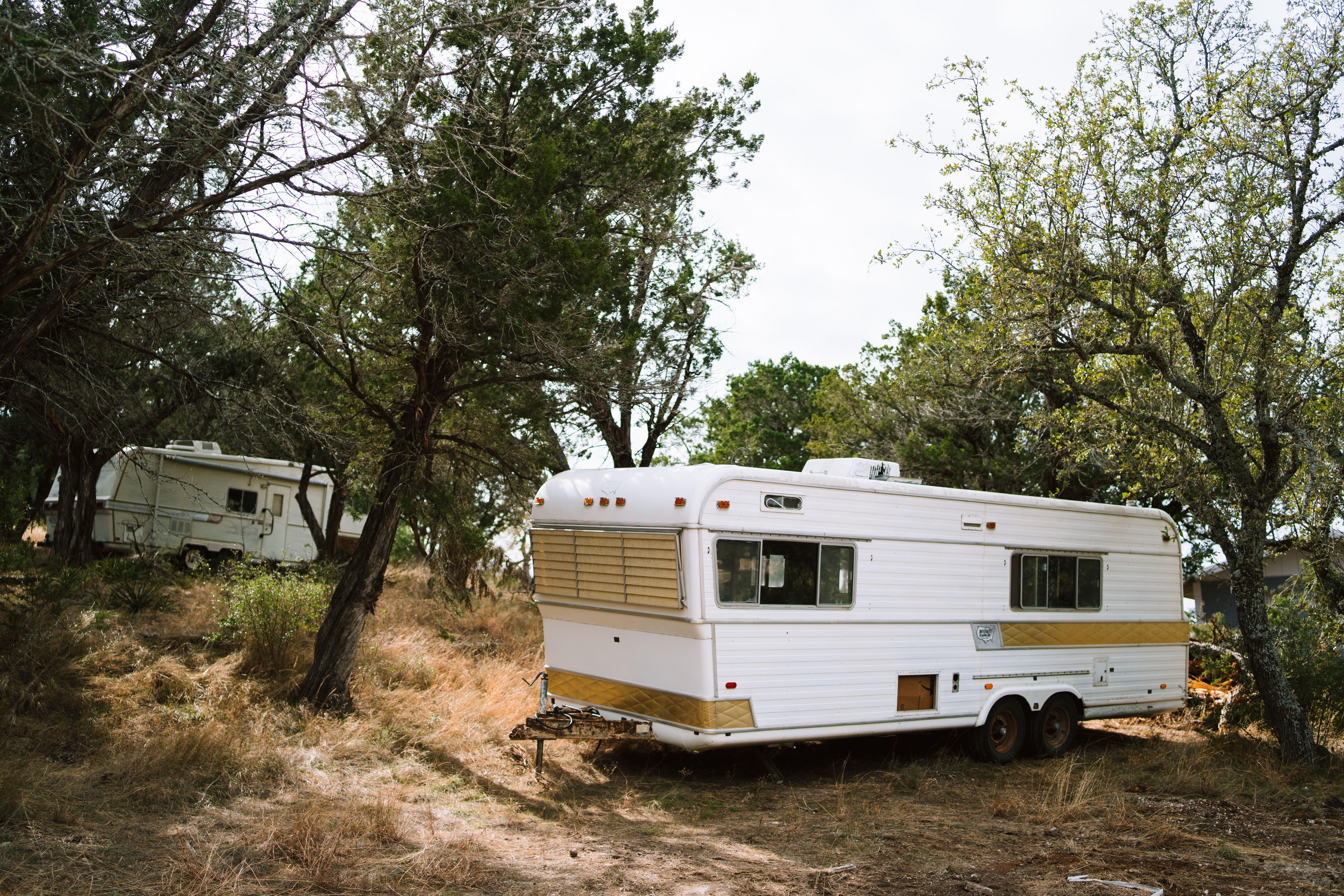 Older trailers among trees on Central Texas land