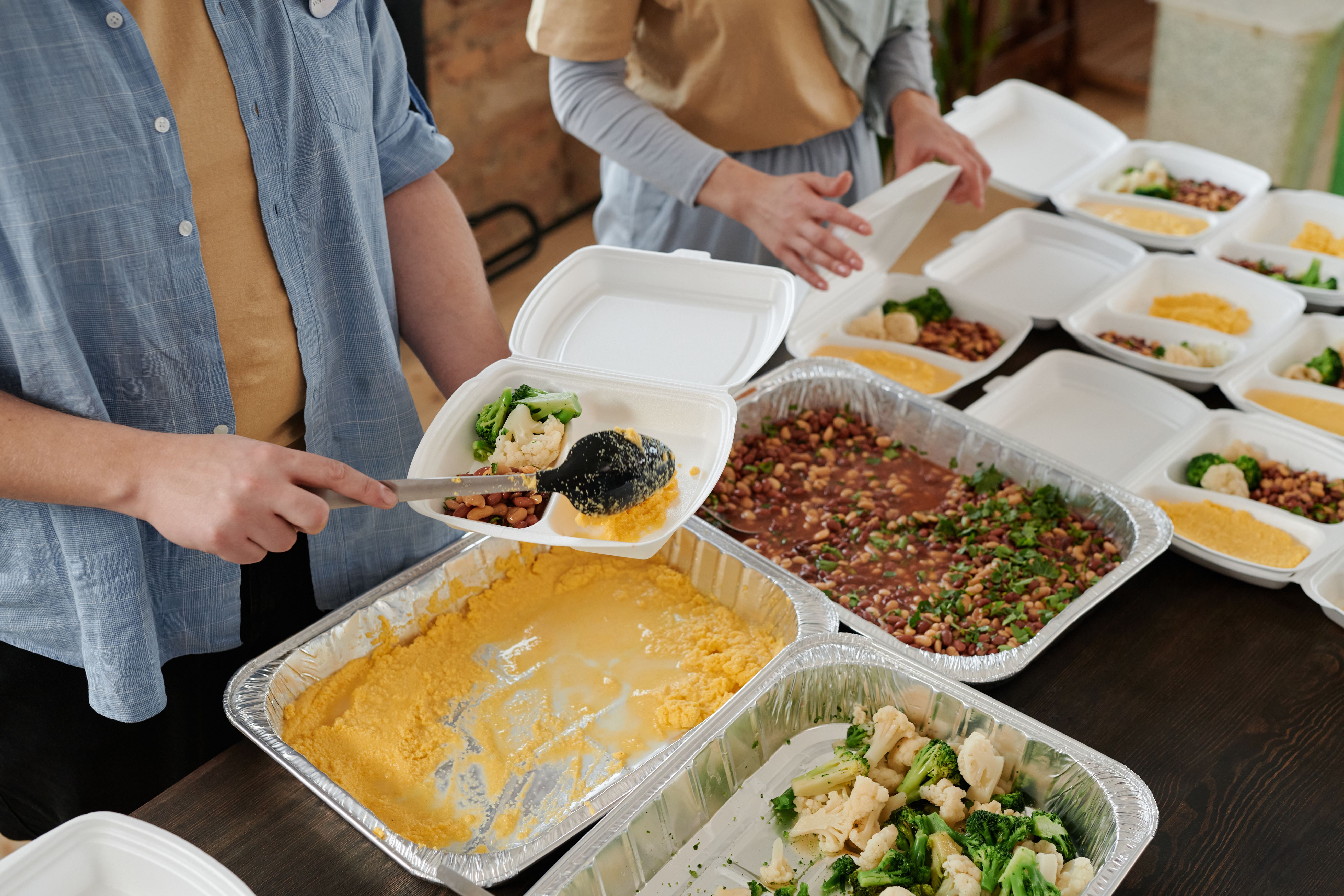 Community members serving food to neighbors