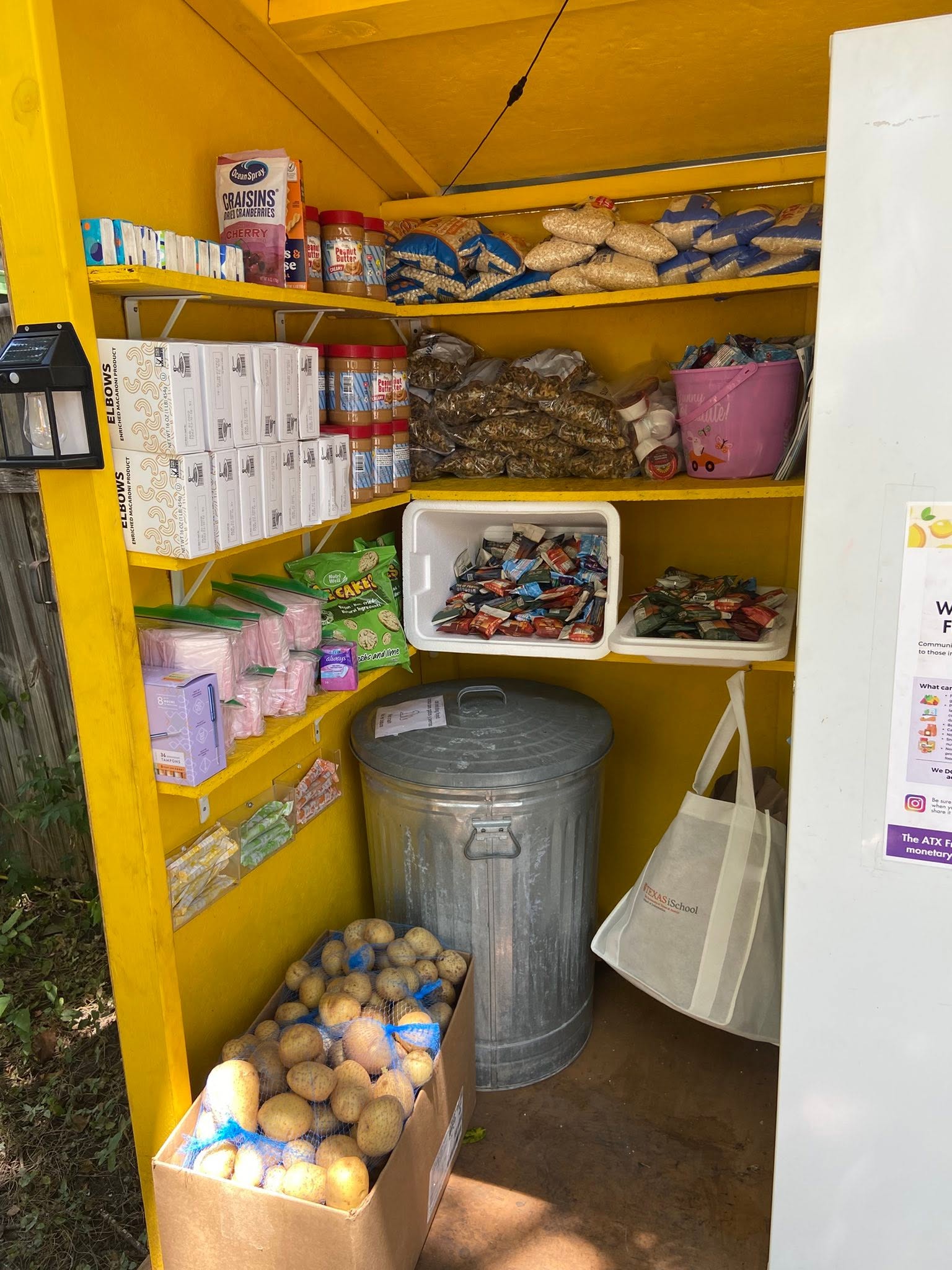 Central Texas neighborhood community refrigerator stocked with produce and milk